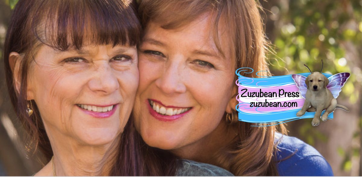Marcy and Scottie Jeanette with the Zuzubean Press logo overlaid (trans flag with "Zuzubean Press" written and an image of Zuzu the yellow lab in butterfly wings